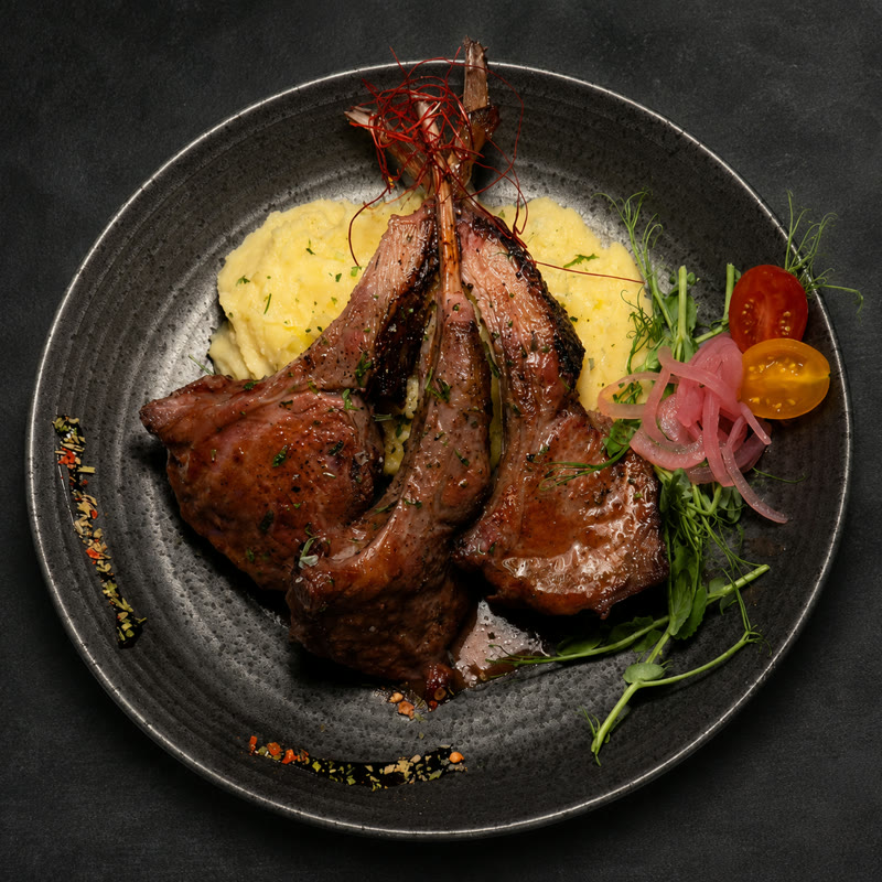 Josper charcoal-grilled lamb chops with potato purée, microgreens and pickled onions at Renzo's St. Pete