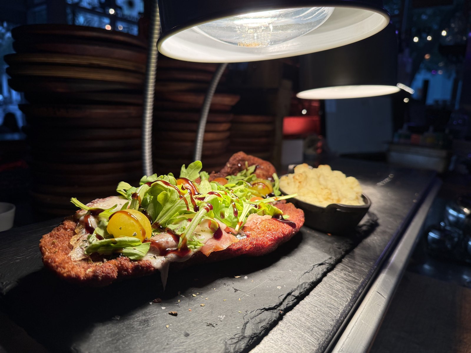 Milanesa Supreme — breaded NY strip topped with dressed greens, served with potato purée at the counter at Renzo's St. Pete